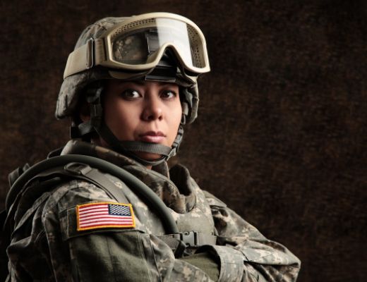 Headshot of woman in military gear with her arms crossed
