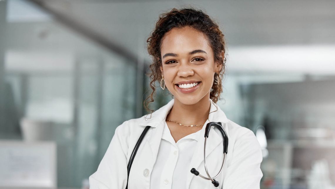 Healthcare worker smiling wearing a stethoscope