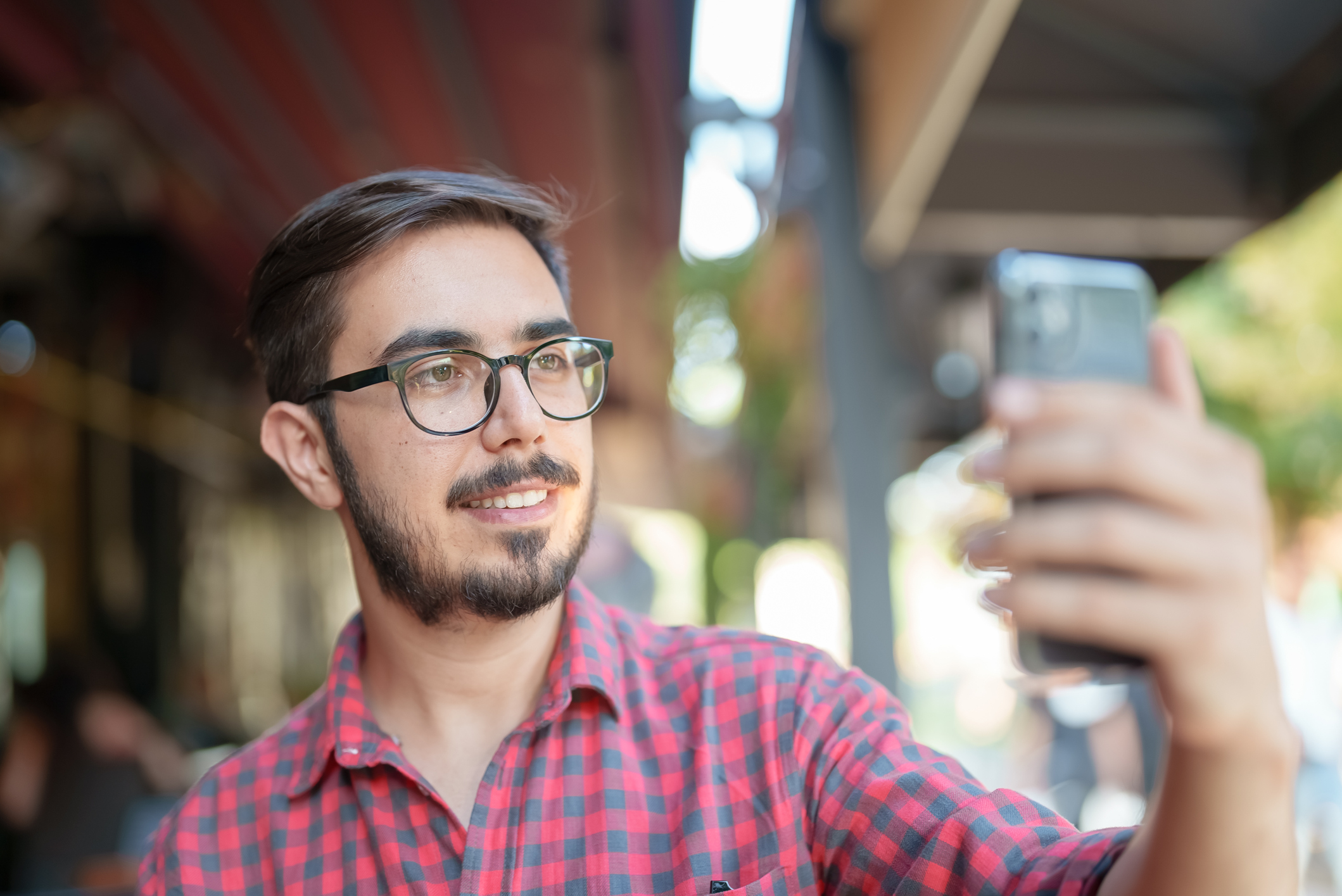 Young man using facial recognition on mobile phone